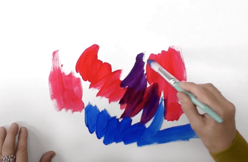 light skinned hand painting red and blue